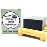A box of Savvy Fit Soaps Sports Bar in Charcoal & Eucalyptus with an open soap, highlighting its plant-based, USA-made, and refreshing skincare formula.